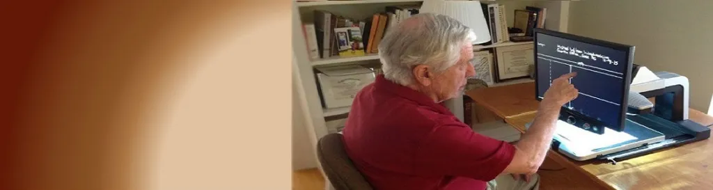 Man using Assistive Device to read